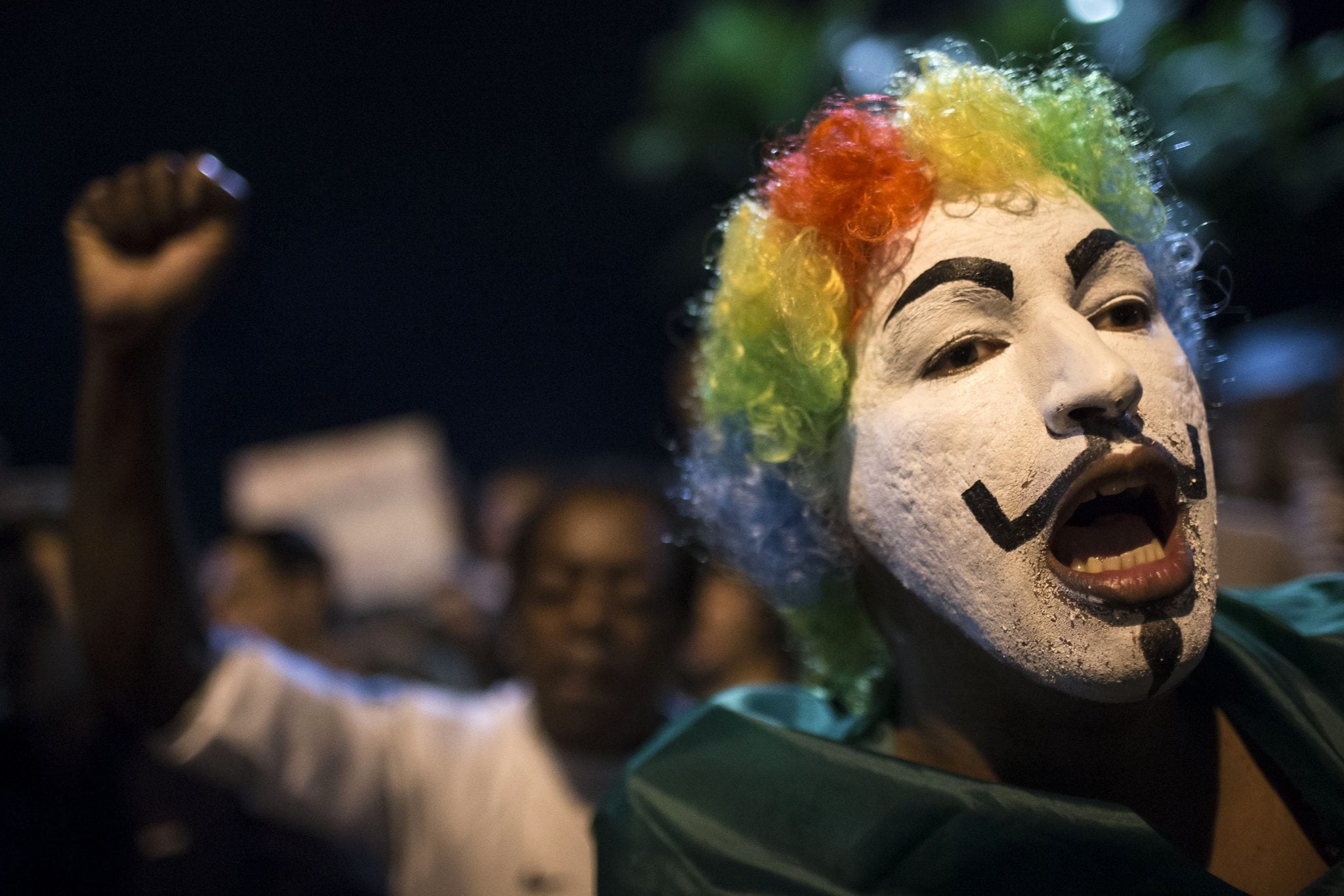 A man shouts slogans during a protest outside the home of Sergio Cabral, the governor of Rio de Janeiro state, in Rio de Janeiro, Brazil, Sunday, June 23, 2013. 